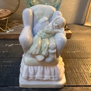 Sweet vintage porcelain figurine of little girl sleeping on a chair